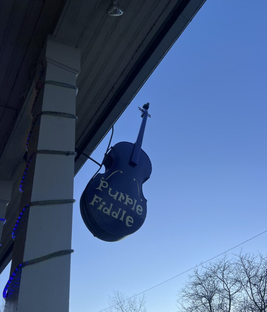 Purple Fiddle Sign outside the establishment (a fiddle dangling in the air)